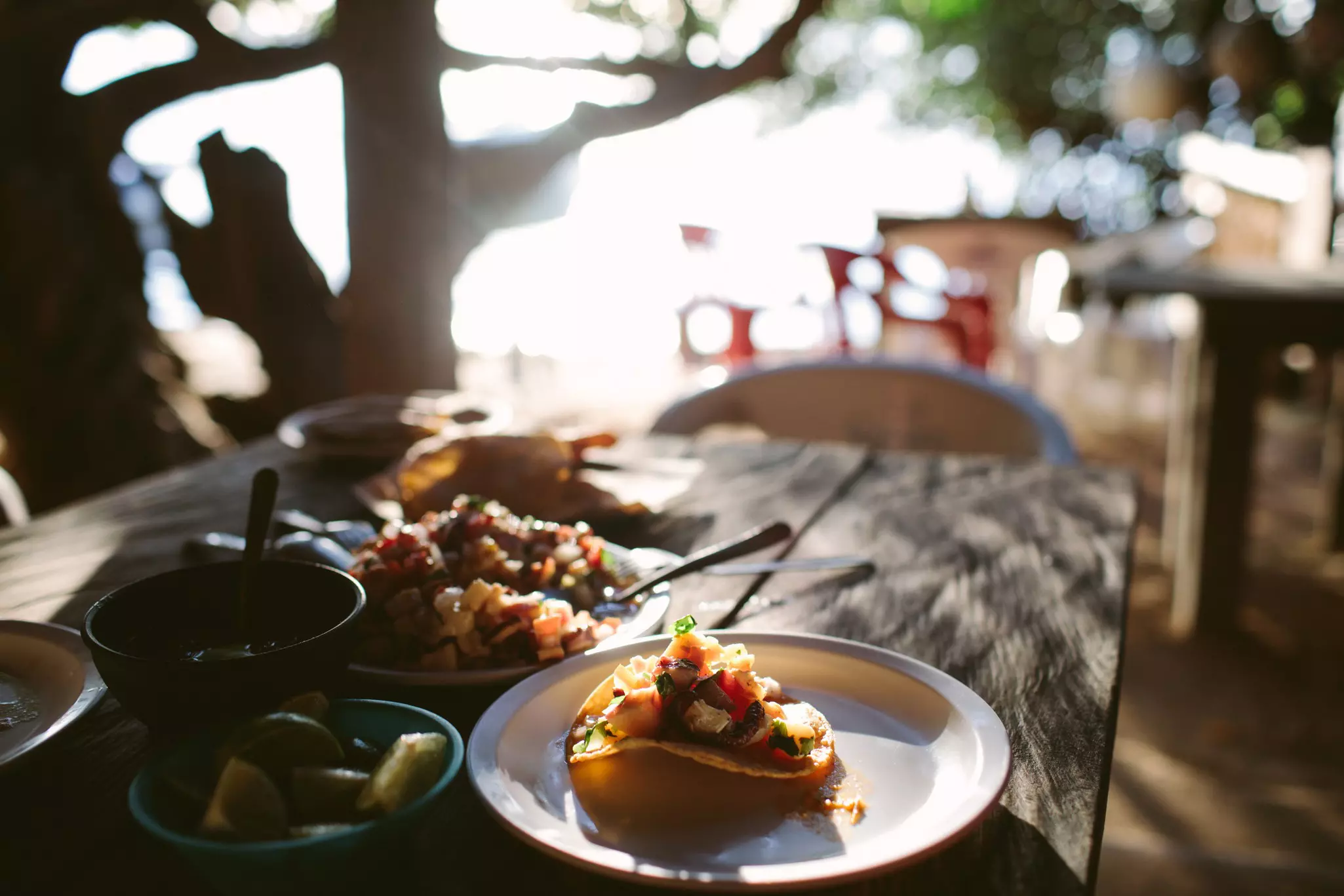 Traditional Mayan food Cancun Tacos  on a plate with the beach beyond