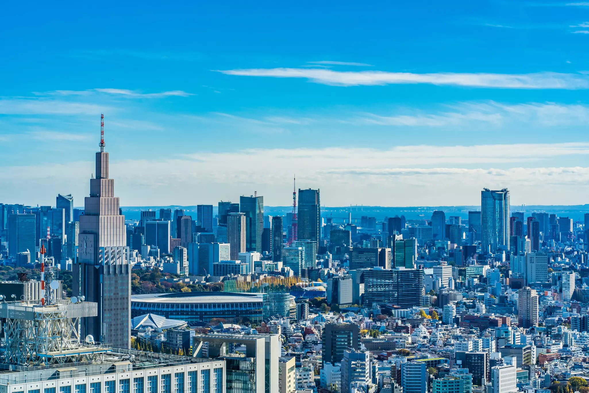 A view of the towers of a city against a blue sky, as seen from an observation deck