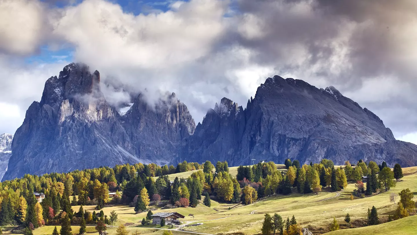 Clouds swirl around the peaks of the Dolomites, as seen from the mountain plateau of Alpe di Siusi (Seiser Alm). Matt Munro / Lonely Planet