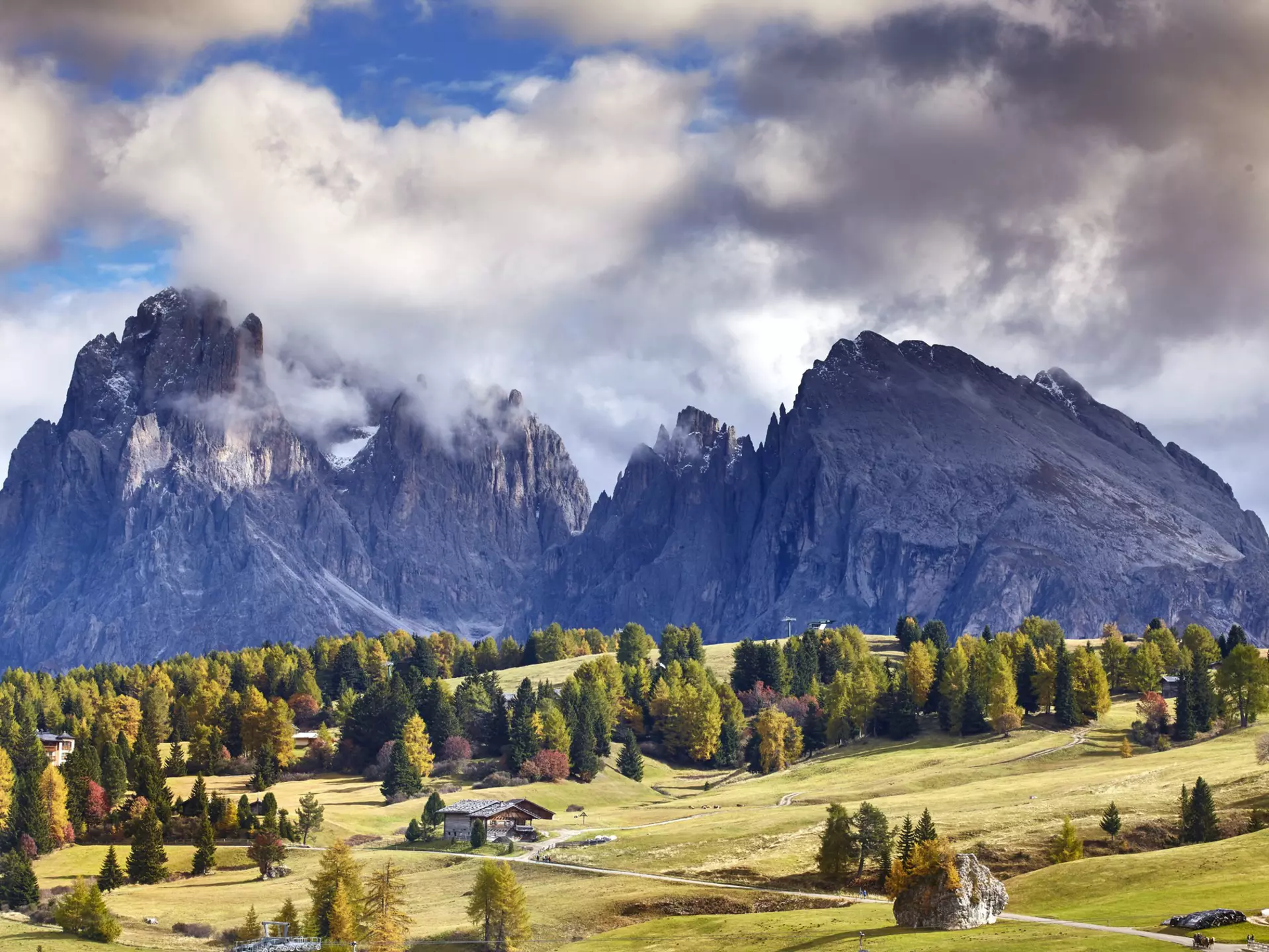 Clouds swirl around the peaks of the Dolomites, as seen from the mountain plateau of Alpe di Siusi (Seiser Alm). Matt Munro / Lonely Planet