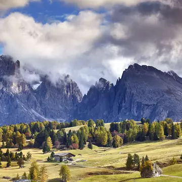Clouds swirl around the peaks of the Dolomites, as seen from the mountain plateau of Alpe di Siusi (Seiser Alm). Matt Munro / Lonely Planet