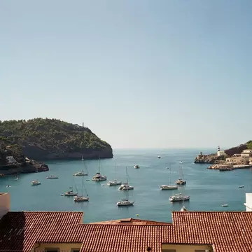 View from window over roof of a hotel and a harbour with boats in Soller, Mallorca