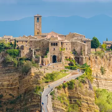 The famous Civita di Bagnoregio hit by the sun on a stormy day. Province of Viterbo, Lazio, Italy.