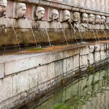 Closeup of the square of the fountain of the 99 spouts located in the historic center of L'Aquila, in Abruzzo, Italy.