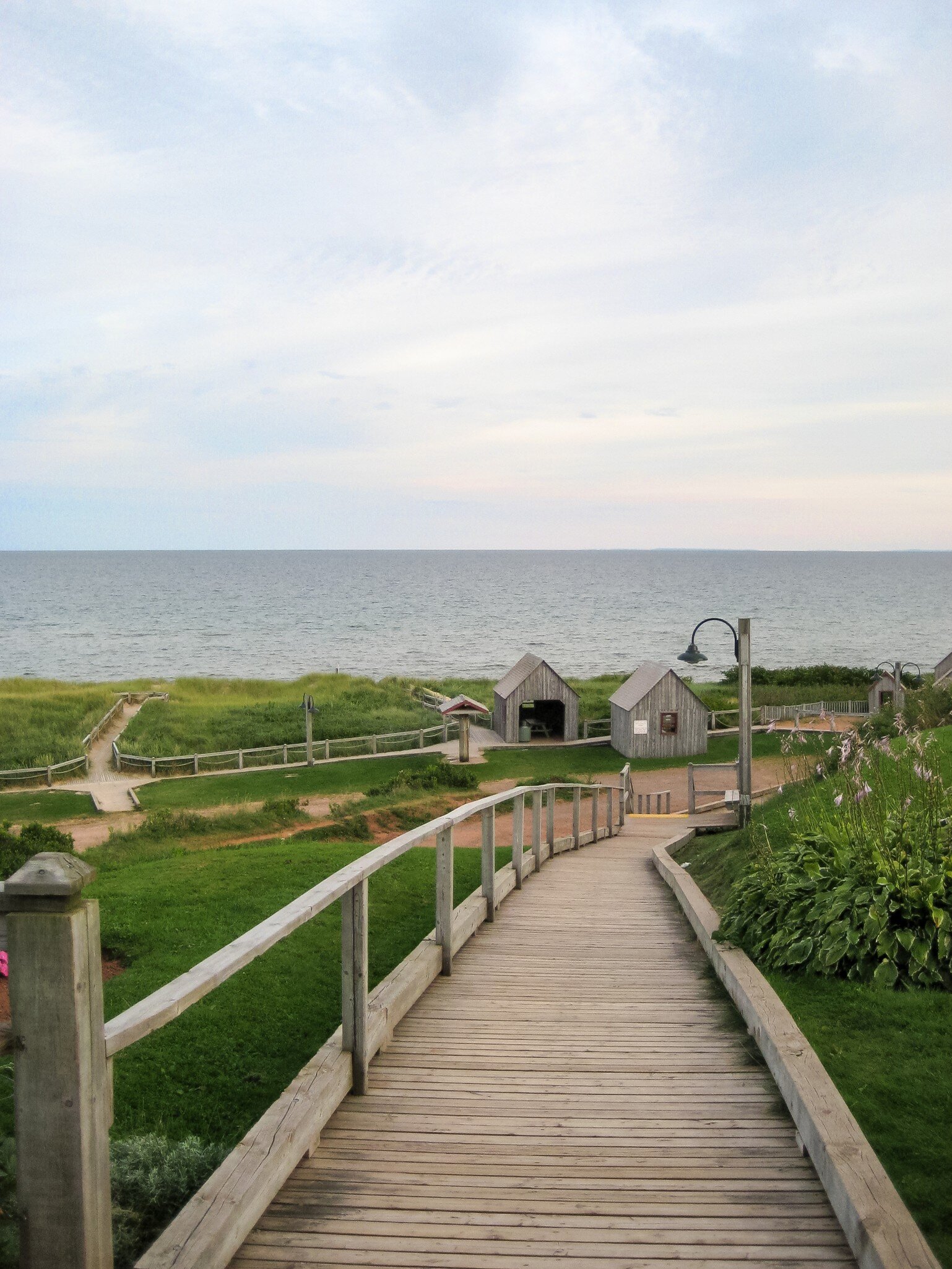 View of a weathered wooden boardwalk next to the Atlantic Ocean at Basin Head Provincial Park on Prince Edward Island, Canada.
