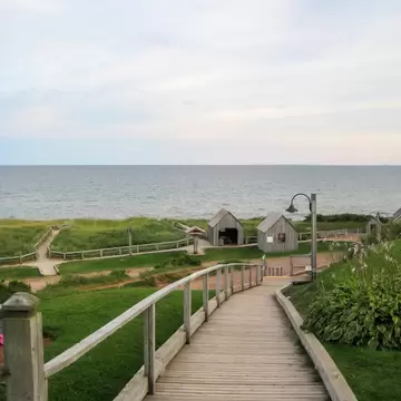 View of a weathered wooden boardwalk next to the Atlantic Ocean at Basin Head Provincial Park on Prince Edward Island, Canada.