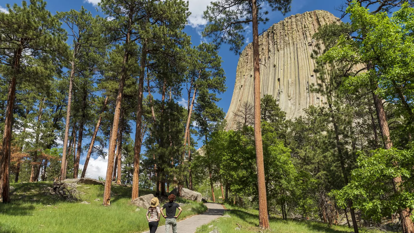 Two hikers looking at Devils Tower