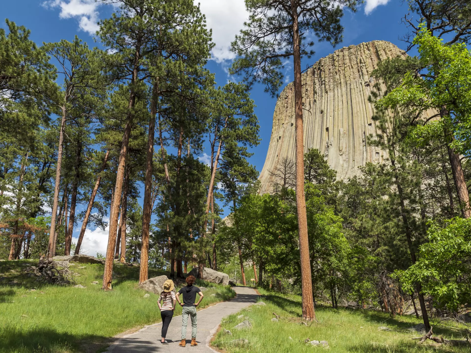Two hikers looking at Devils Tower
