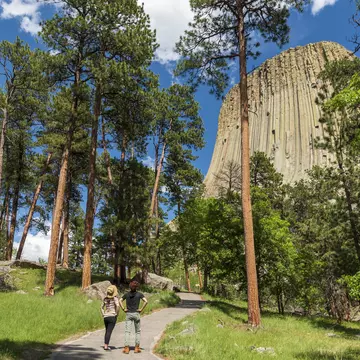 Two hikers looking at Devils Tower