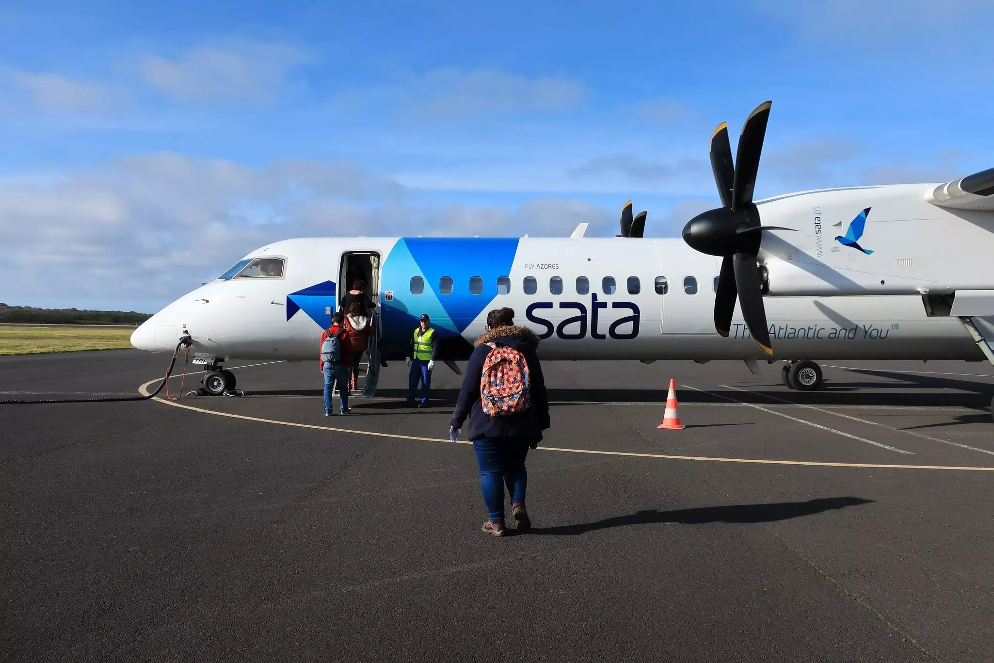 Passengers boarding a turboprop plane for an inter-island flight in the Azores.