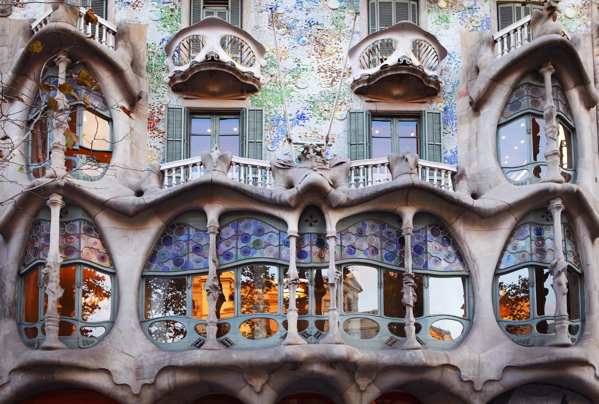 Carvings, stained glass and colorful exterior decorations on a building in Barcelona, Spain.