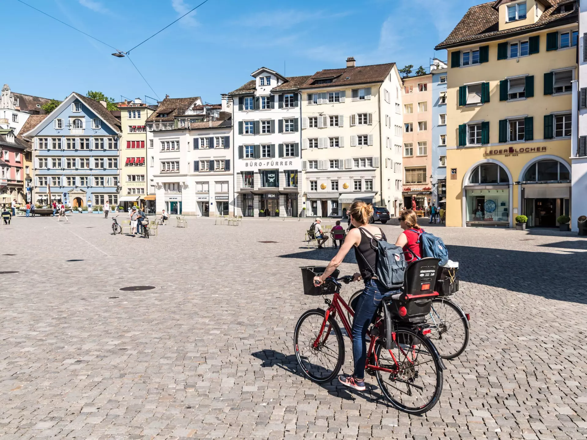 Two young ladies ride bicycles through a town square in Zurich.
693239720
Young Adult, Adult, Adults Only, Travel, Switzerland, European Culture, Summer, Famous Place, Women, Building Exterior, Capital Cities, Zurich, Young Women, Day, 20-24 Years, Cycling, Two People, People, Vacations, Town Square, Journey, City, Photography, Outdoors, Horizontal, Only Women, Europe