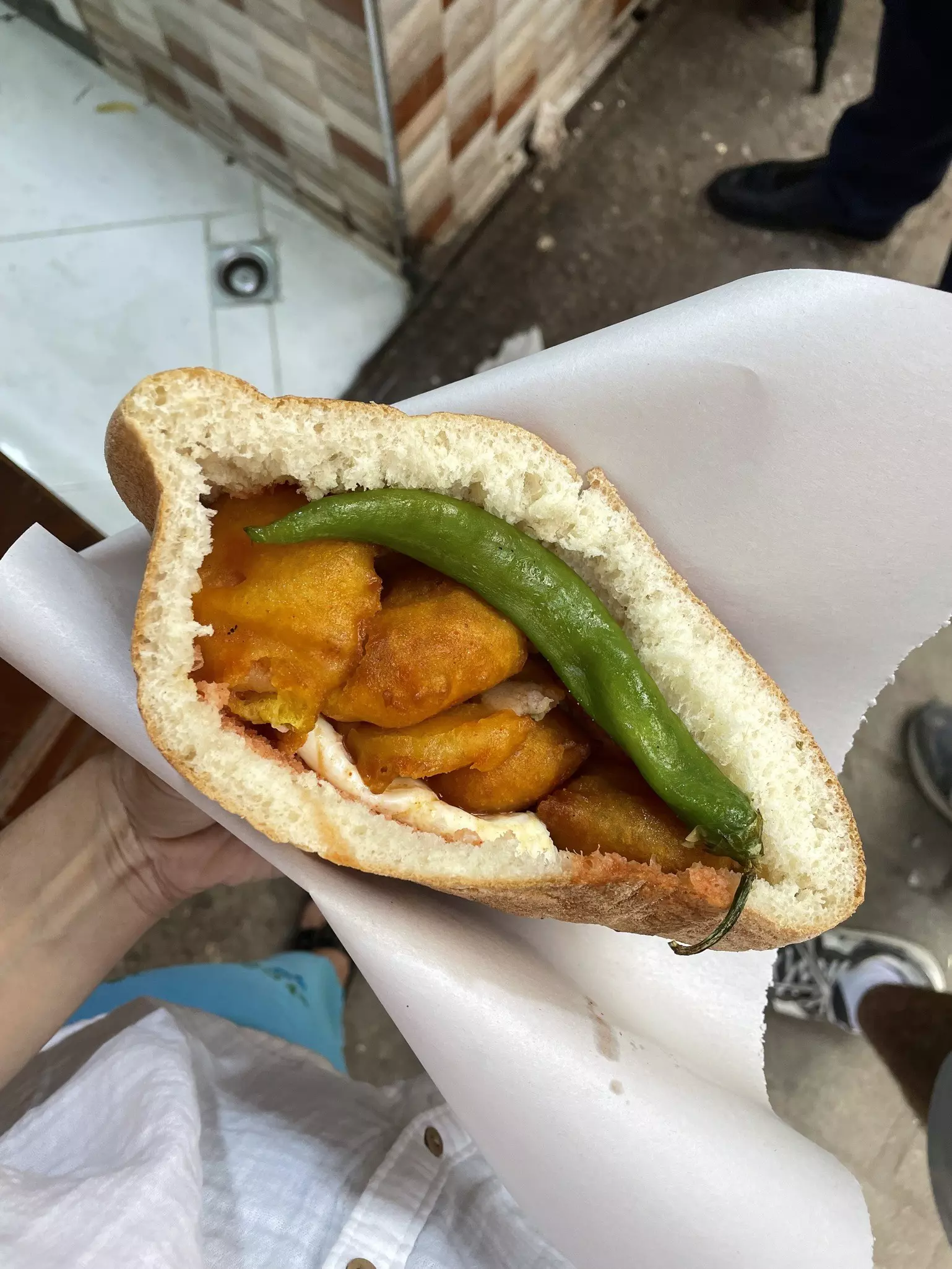Hand holding Maakouda (potato cakes) in Fez, Morocco