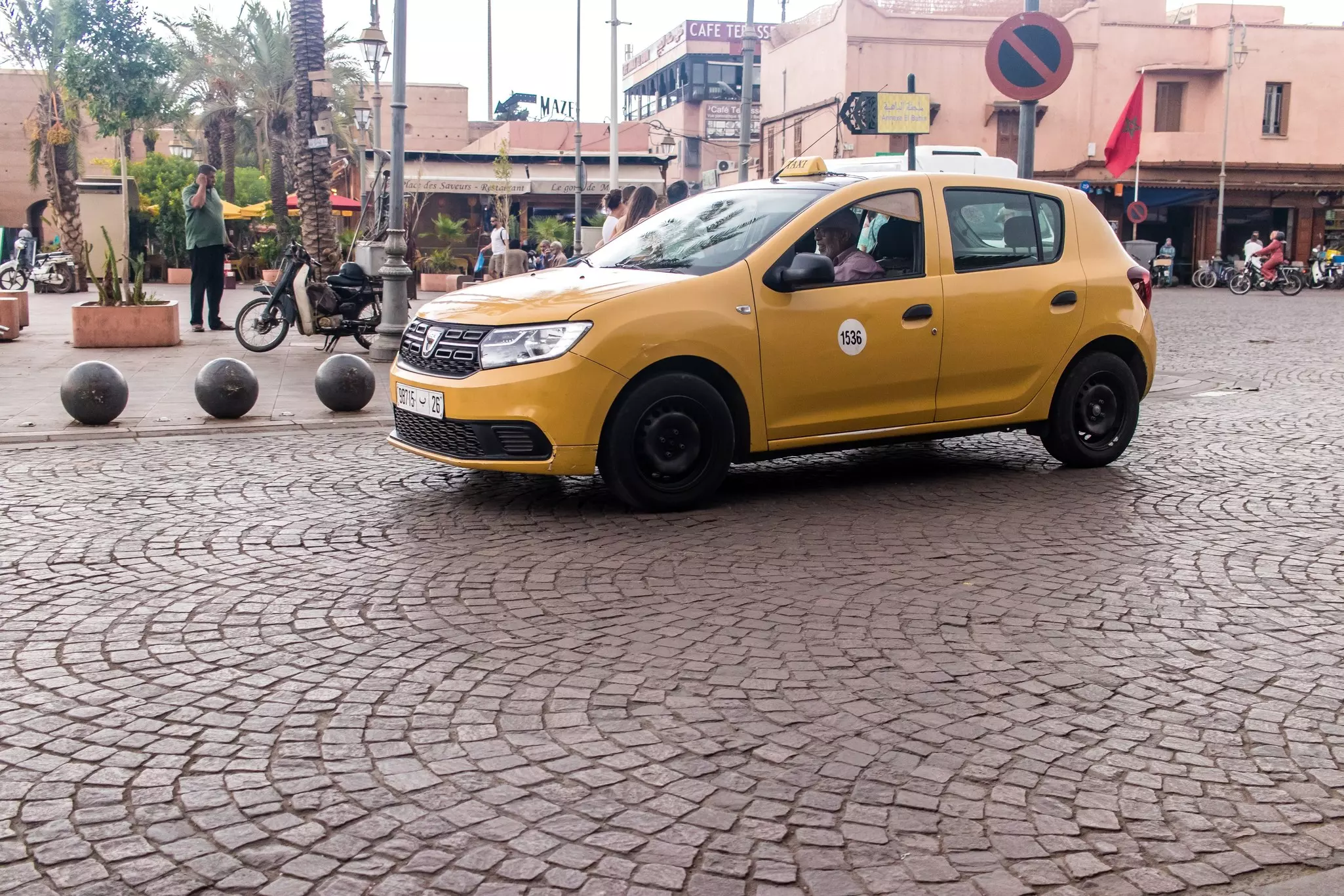 Yellow taxi driving through the streets of Marrakesh