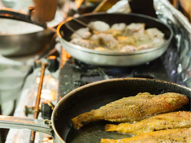 Pan fried snapper cooked on a hob at a market