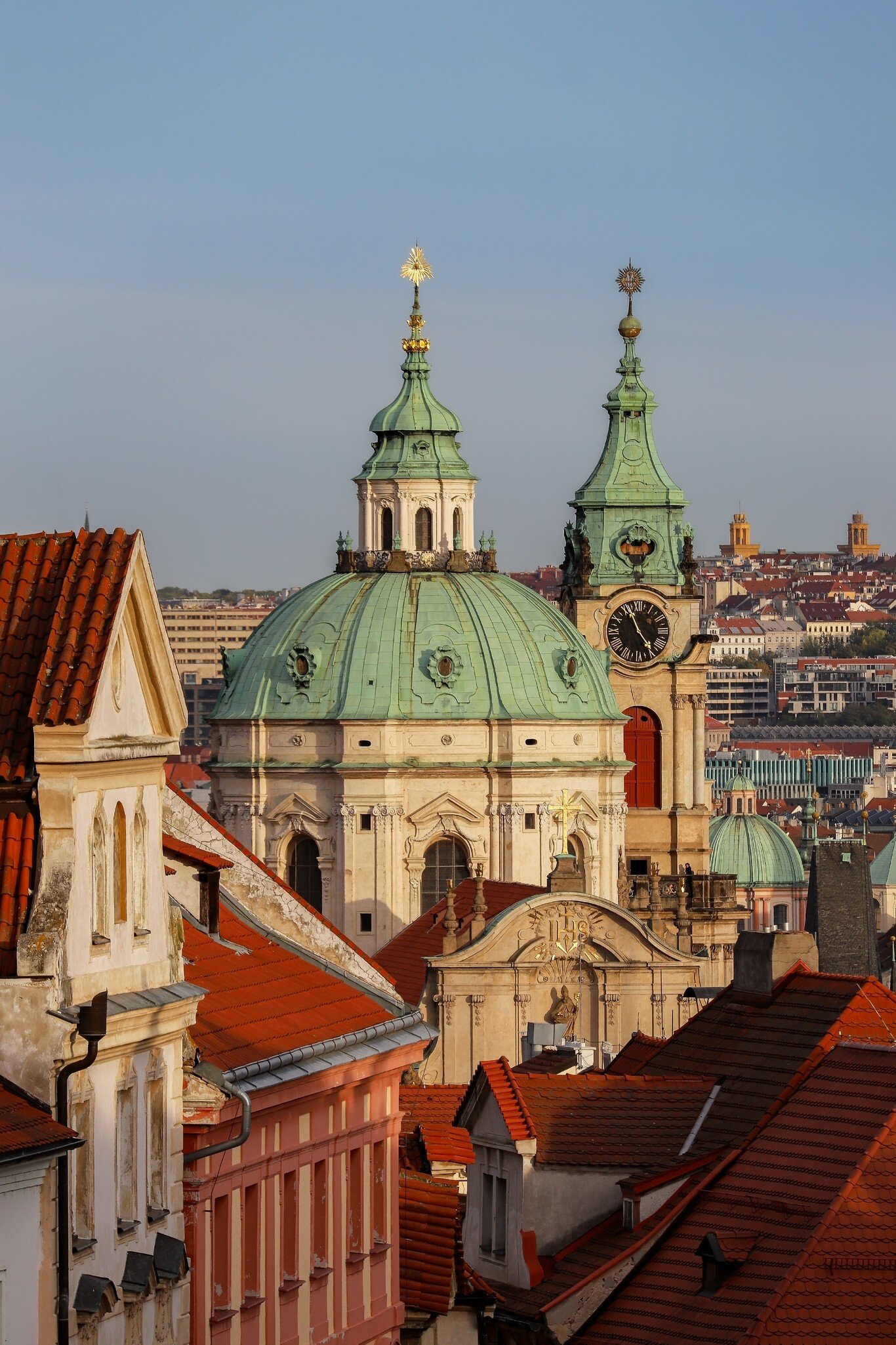 A view of the dome and bell tower of St.Nicholas Church and rooftops of Nerudova street. Prague, Czech Republic.