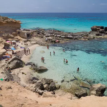 Formentera, Spain - June 7, 2025: Turquoise Waters at Calo des Mort in Formentera, Balearic Islands, Spain.