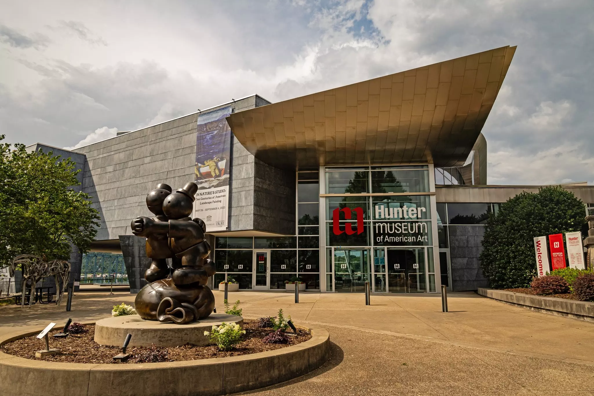 A large figurative sculpture outside a museum of art