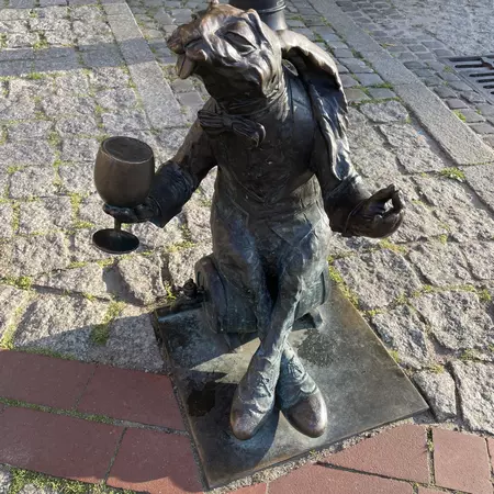Statue of a rabbit with a wine glass in hand