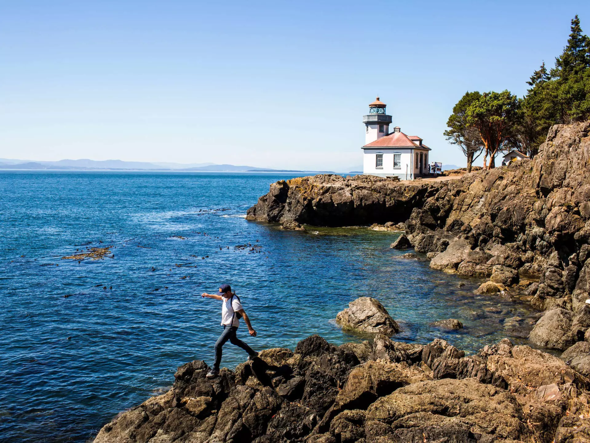 Caucasian man walking on rocks near the lighthouse on San Juan Island, Washington
shoreline, person, scenery, panoramic, nature, sea, lighthouse, coast, San Juan Island, Washington