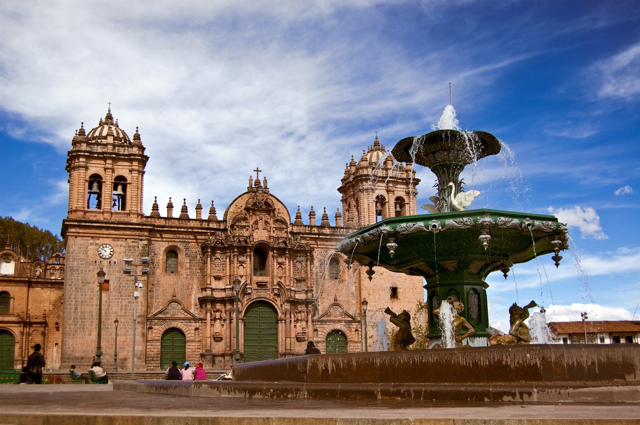 A large fountain and elaborate stone cathedral.