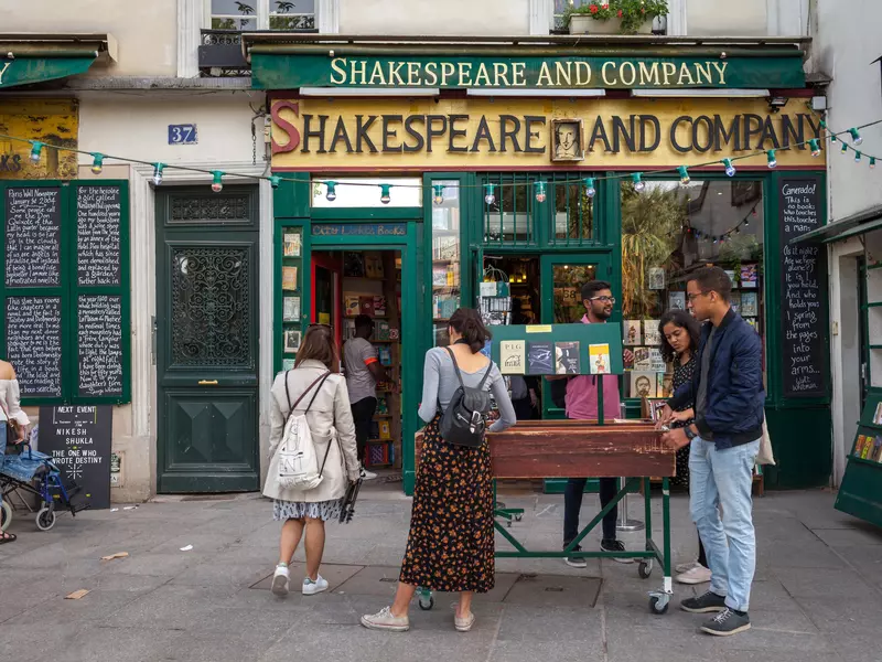 People browsing books displayed for sale outside the famous "Shakespeare and Company" bookstore in the Latin Quarter. 
