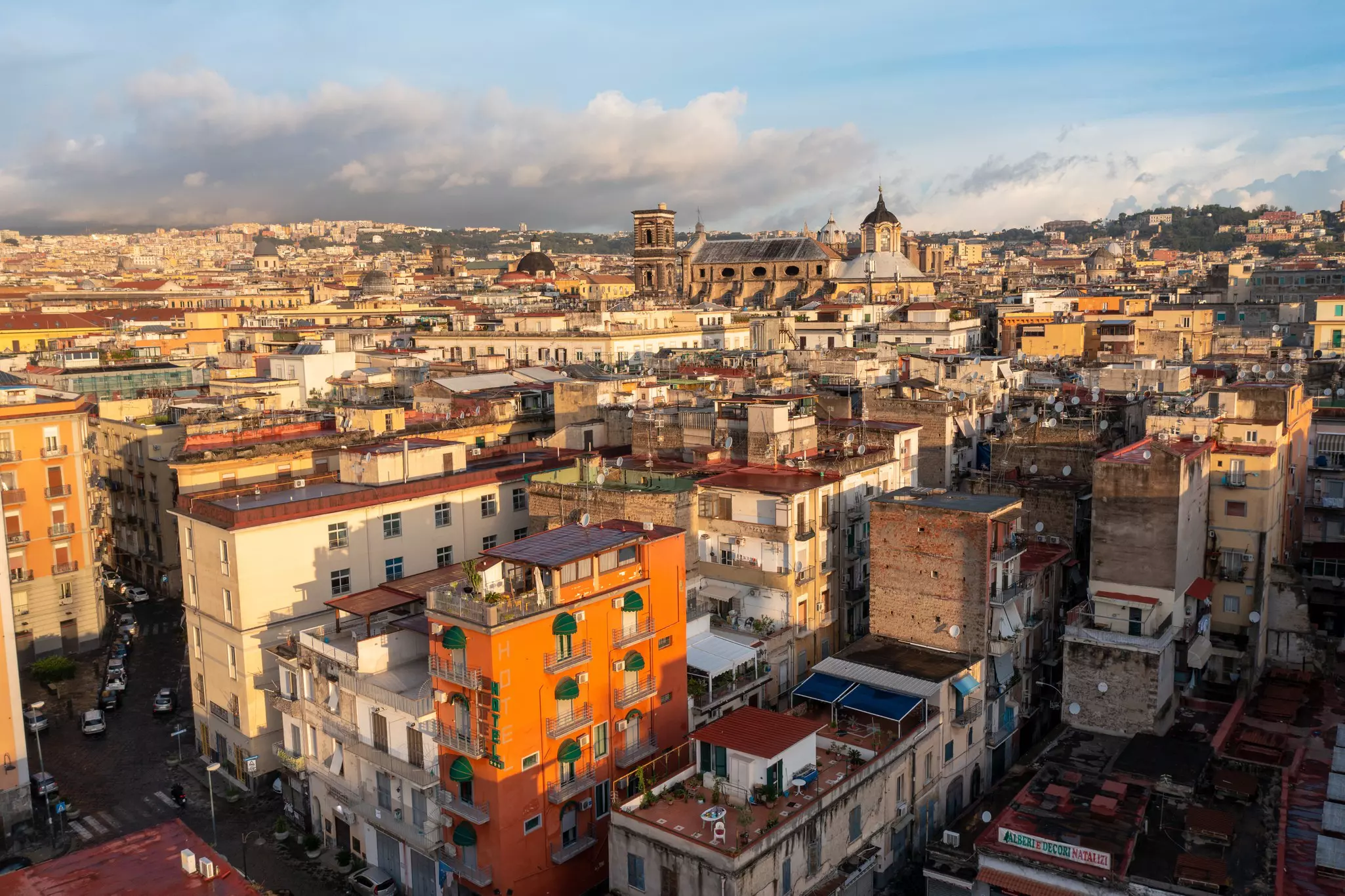 Homes and apartments densely packed together in the historic center of a city around a church.