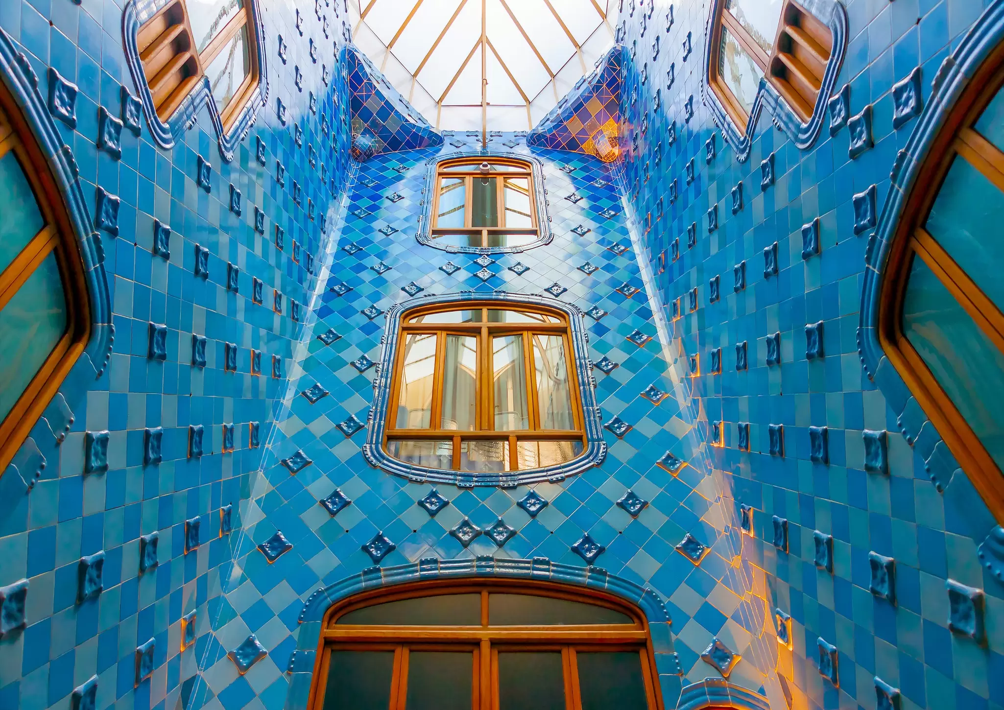 The blue-tiled interior of the famous Casa Battló building designed by Antonio Gaudi in Barcelona, Spain