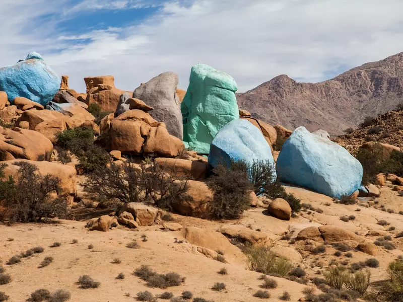 Rocks painted bright blue and turquoise in the mountains of southern Morocco.