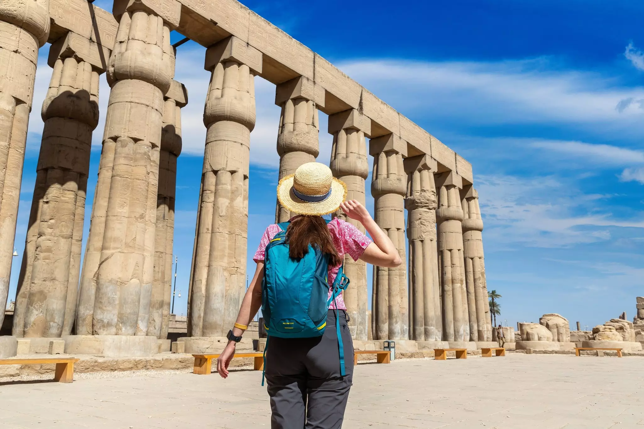 Woman tourist standing at Luxor Temple on a sunny day