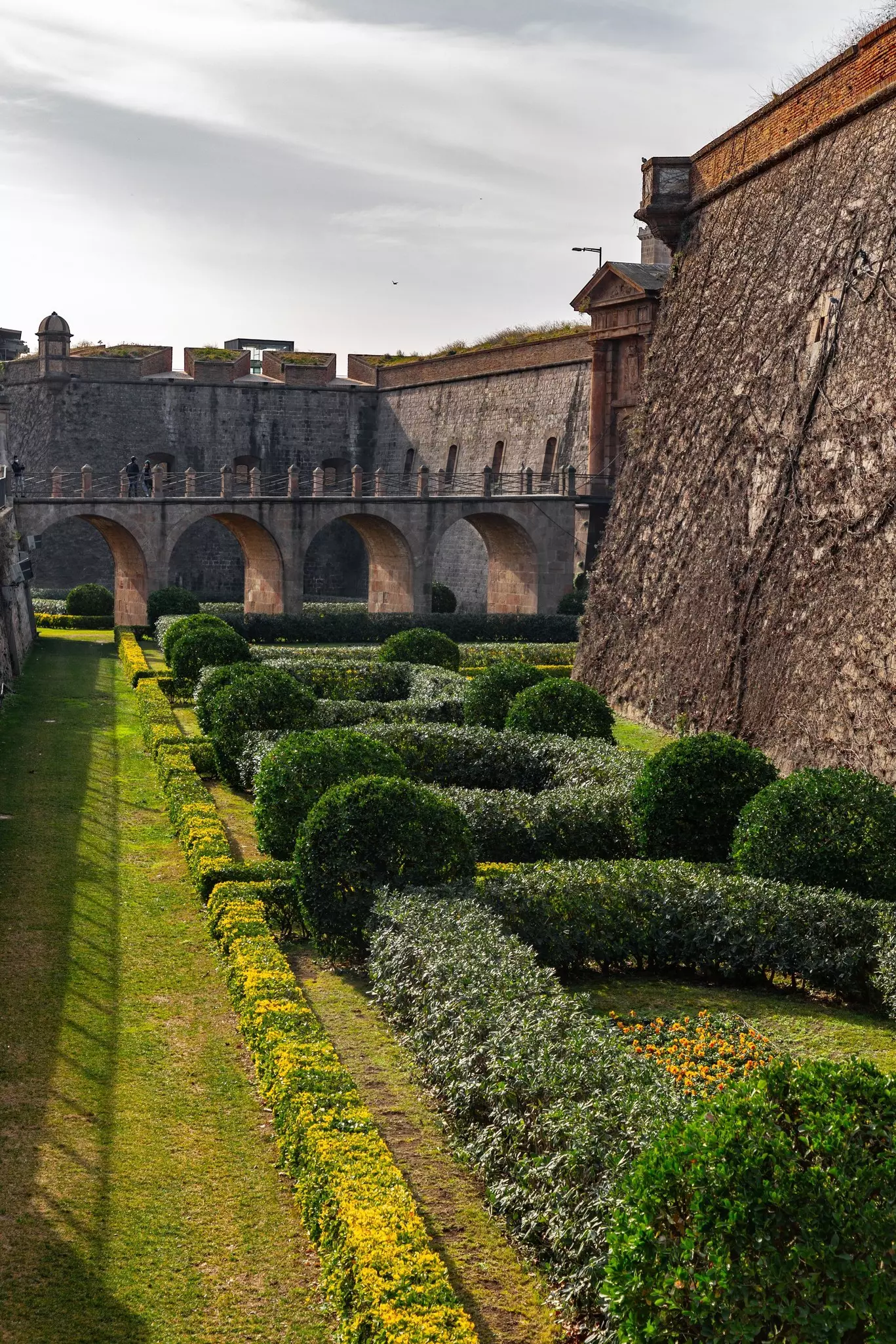 Montjuic Castle in Barcelona, Catalonia, Spain, with lush greenery in the foreground