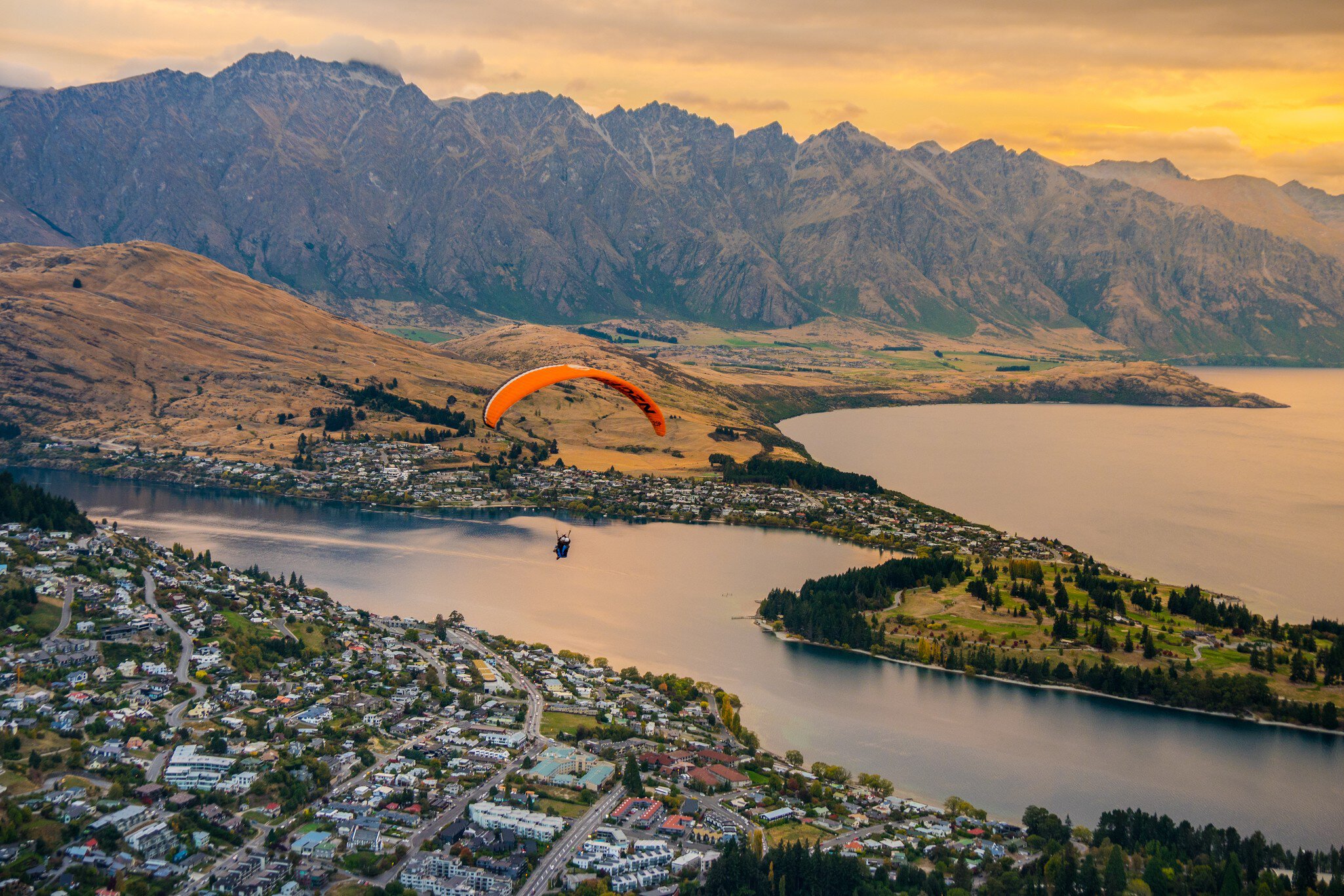 Paragliding over Queenstown and Lake Wakaitipu with The Remarkables in the background from viewpoint at Queenstown Skyline, New Zealand, License Type: media, Download Time: 2025-03-07T16:15:16.000Z, User: rhylton_redventures, Editorial: false, purchase_order: 56530 - Guidebooks, job: Lonely Planet WIP, client: Lonely Planet WIP, other: Rhianydd Hylton