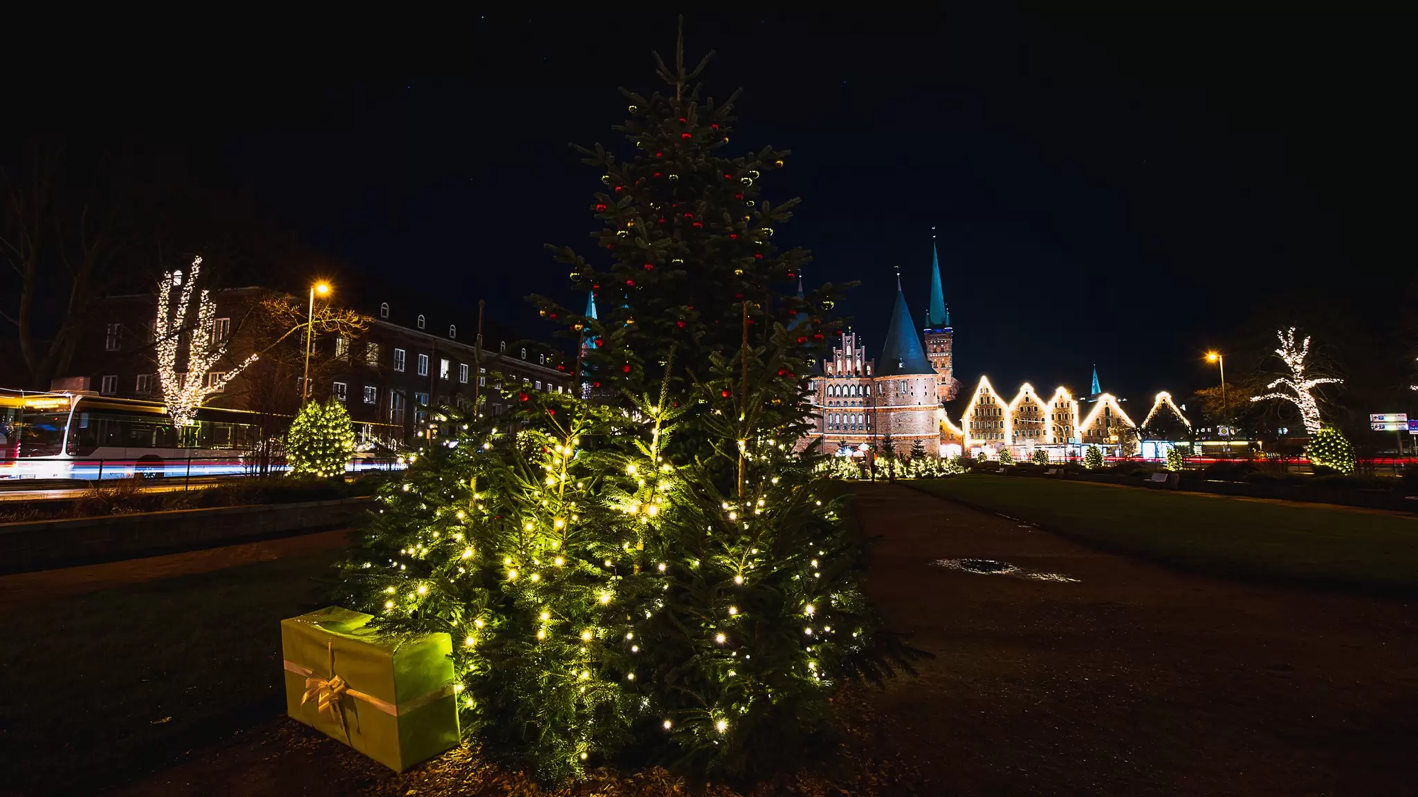 The beautiful Christmas tree with lights in front of the Holsten Gate in Lübeck City, Germany