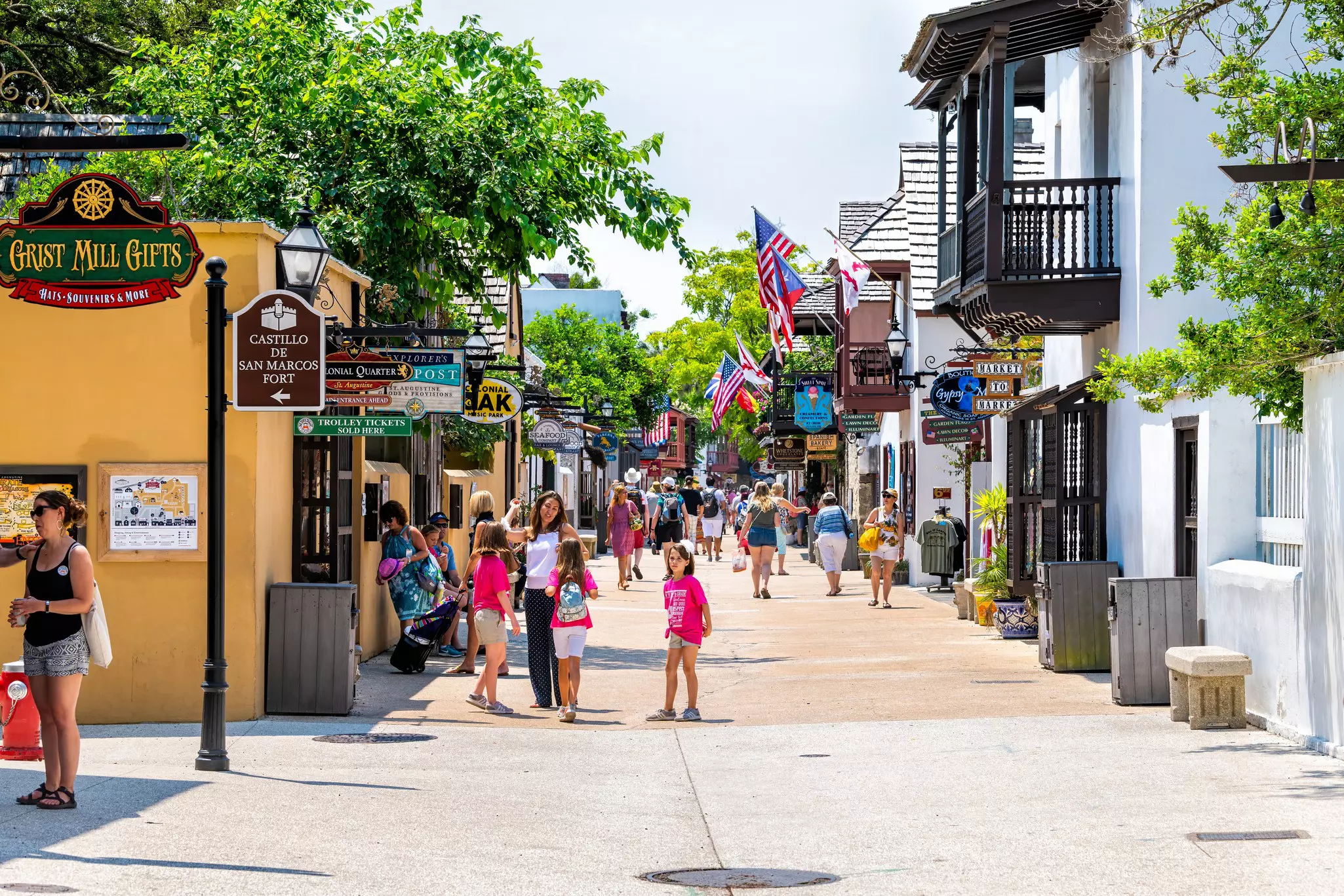 People walking and shopping on St George Street in St Augustine on summer day by stores shops and restaurants in old town Colonial quarter