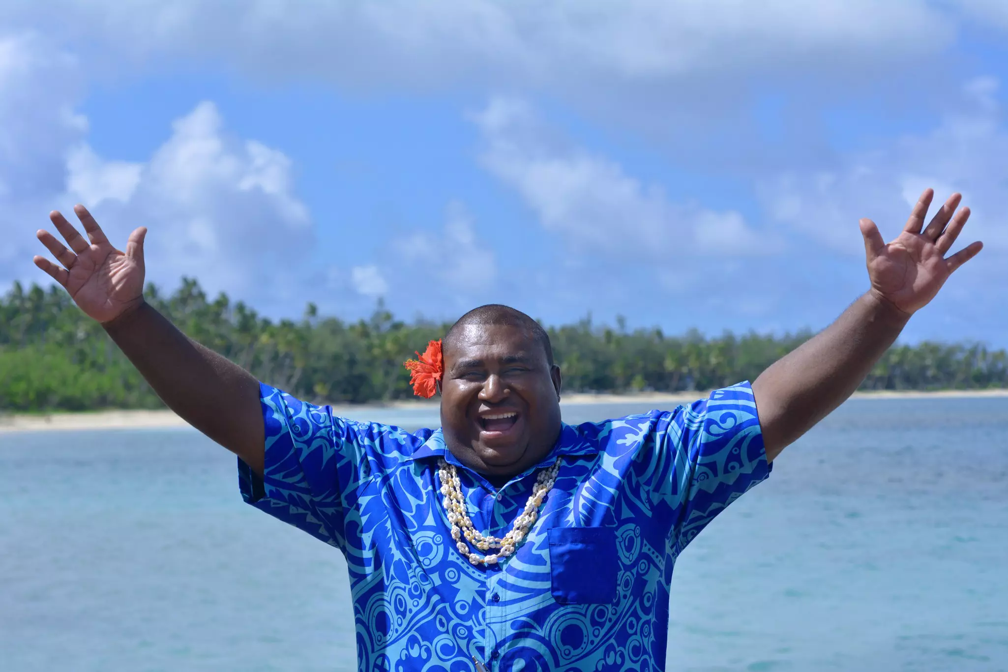 Smiling Fijian man against background of the Blue Lagoon in Fiji