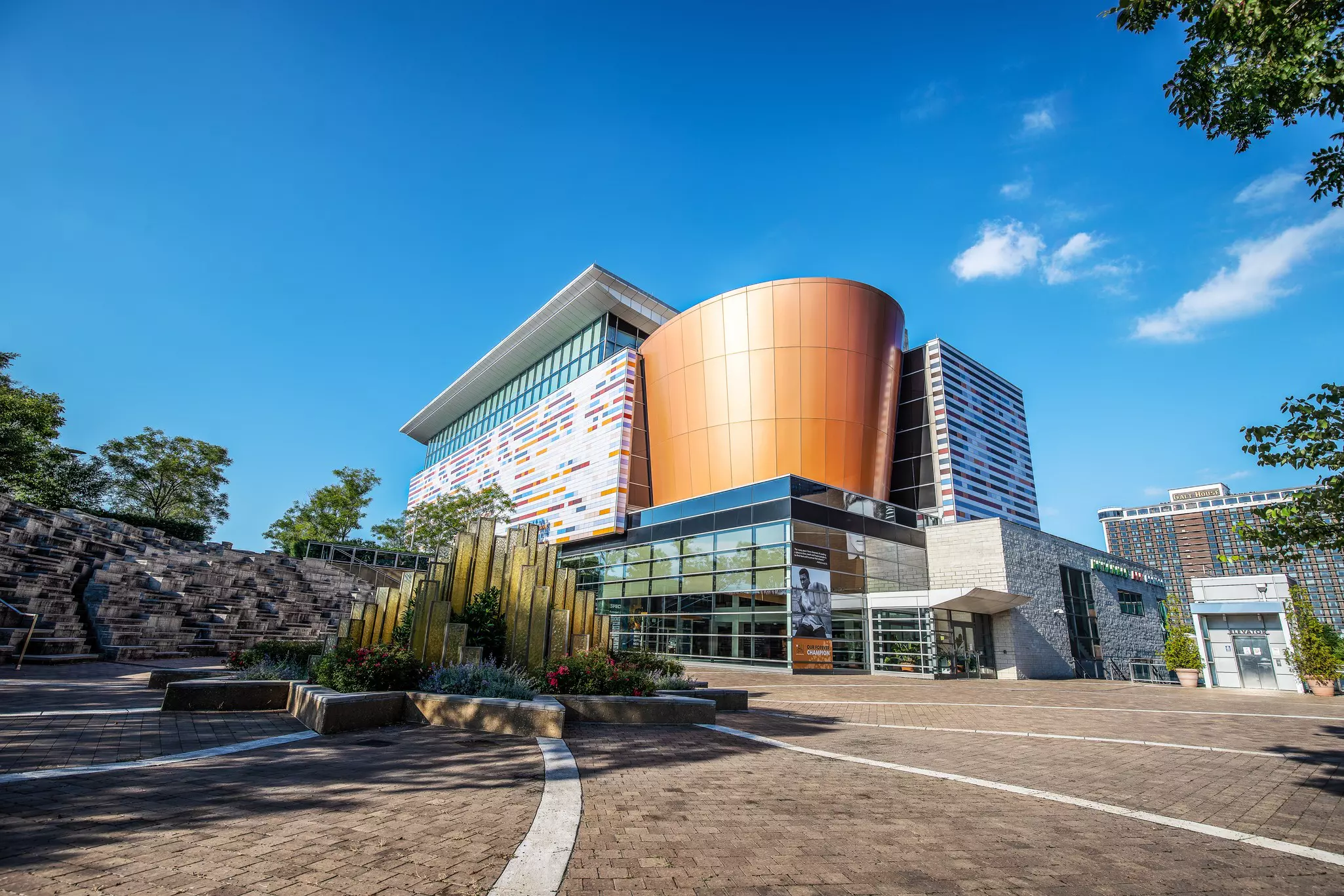 Wide exterior shot of museum with modern architecture and a cobblestone courtyard.