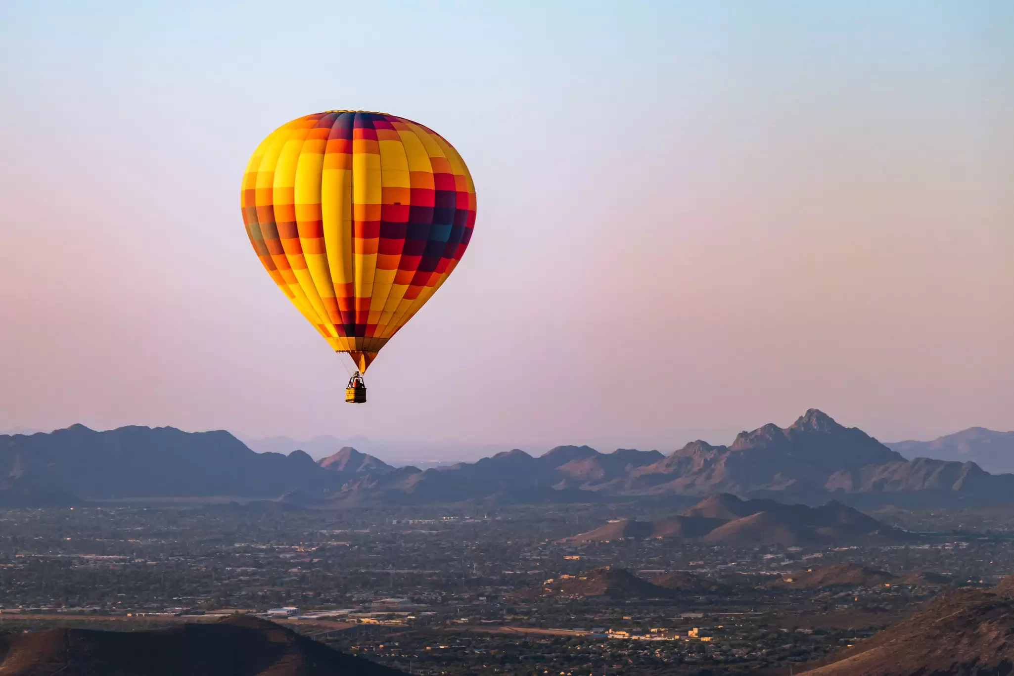 A hot-air balloon flies over Phoenix, Arizona. RaulCano/Shutterstock