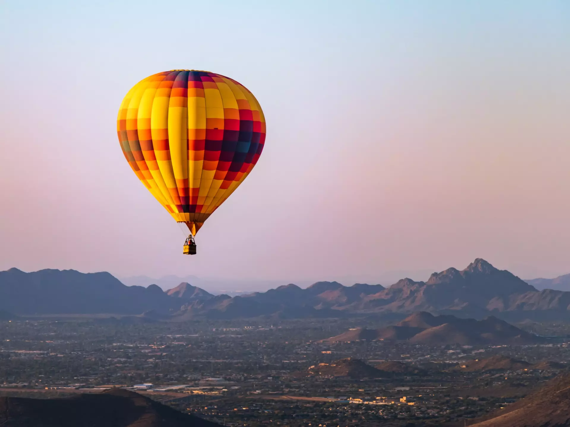 A hot-air balloon flies over Phoenix, Arizona. RaulCano/Shutterstock