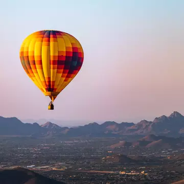 A hot-air balloon flies over Phoenix, Arizona. RaulCano/Shutterstock