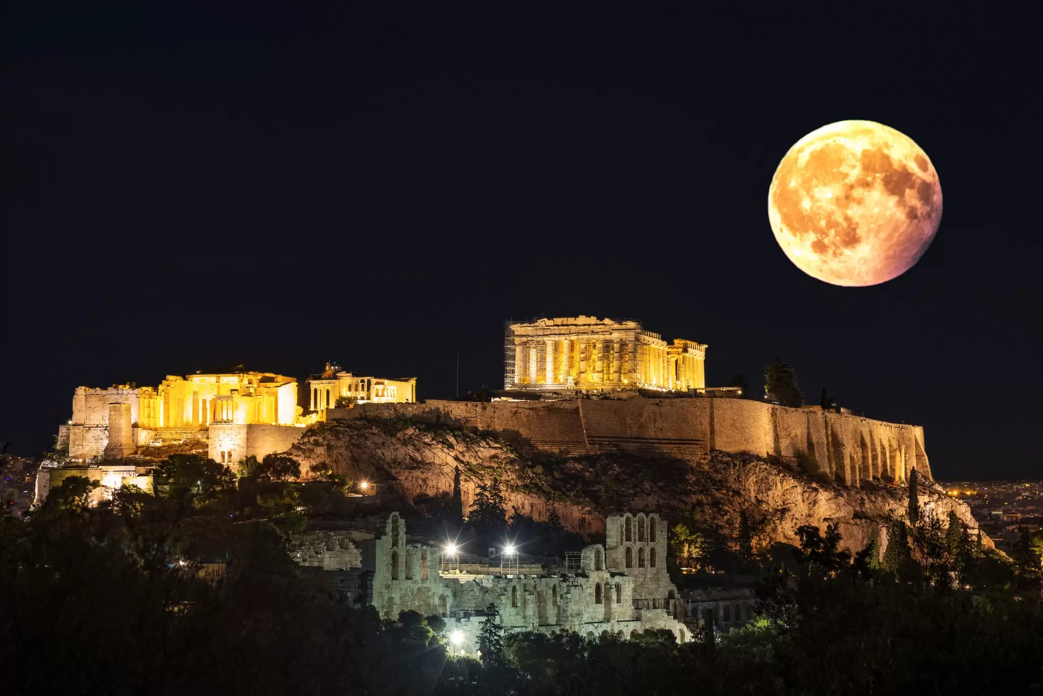 The moon rising over the Acropolis in Athens, Greece