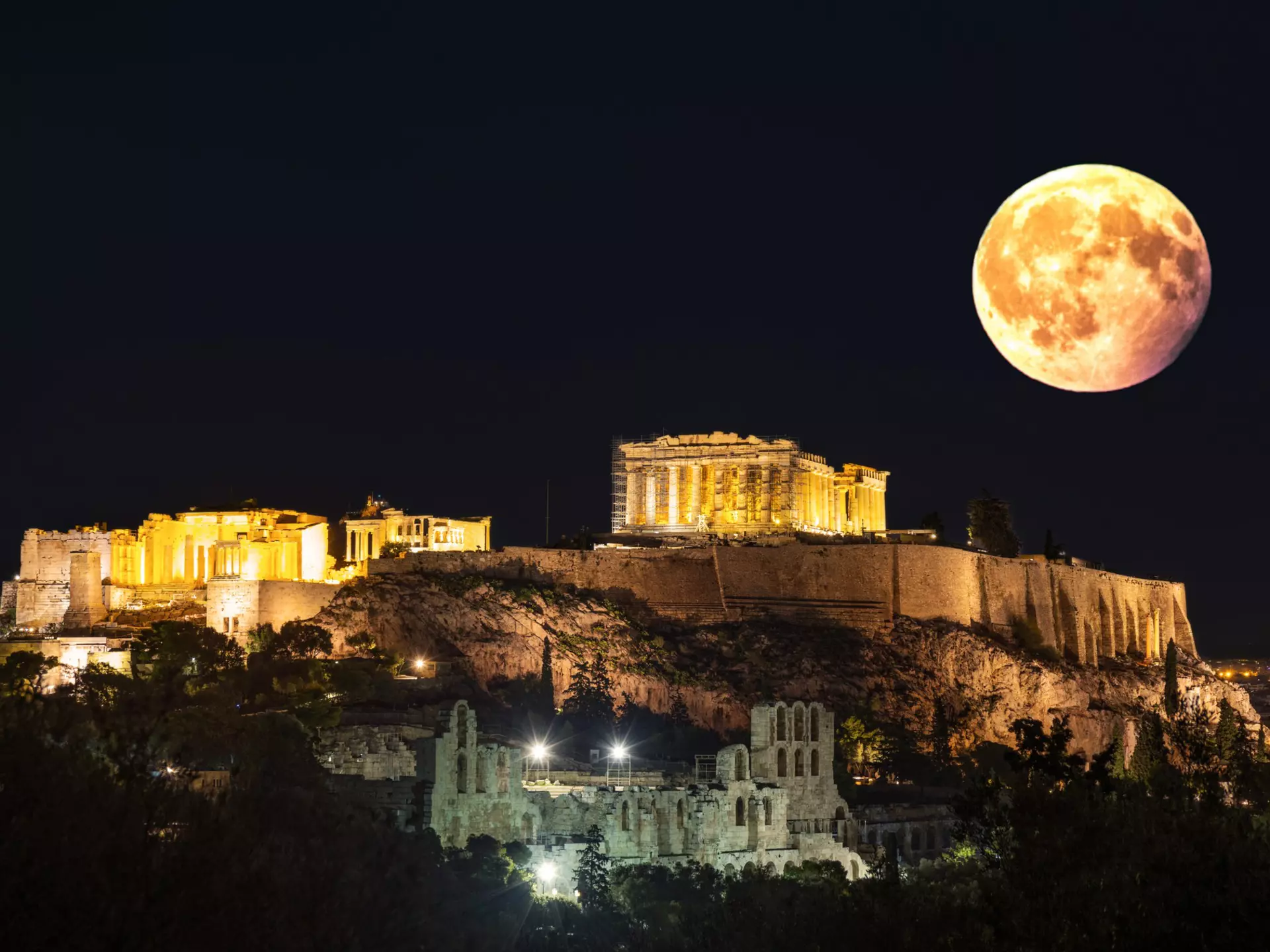 1 January 2018, Athens Greece: The Acropolis of Athens photographed from the nearby Pnyka, the place where ancient Athenians gathered to debate democracy. The picture is made in the full moon of January 2018. The main building in the picture is the Parthenon, dedicated to goddess Athena. In the foreground, the roman theater build by Hero? can be seen
1 January 2018, Athens Greece: The Acropolis of Athens photographed from the nearby Pnyka, the place where ancient Athenians gathered to debate democracy. The picture is made in the full moon of January 2018. The main building in the picture is the Parthenon, dedicated to goddess Athena. In the foreground, the roman theater build by Heroδ can be seen
902184352
Greek Culture, UNESCO World Heritage Site, Photography, Old, No, No People, Old Ruin, Acropolis - Athens, Vacations, Athena - Greek Goddess, Attica, Amphitheater, Parthenon - Athens, Ancient, Illuminated, Light Effect, Greece, Athens, Hill, Supermoon, Classical Style, Temple - Building, Travel Destinations, Horizontal, Classical Greek, Dusk, Capital Cities, Famous Place, Lighting Equipment, Night, Scaffolding, Moon, Ancient Civilization, Ancient Greece, Athens - Greece, Elgin Marbles, Full Moon