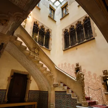 A stairwell with a decorative pattern along the wall.