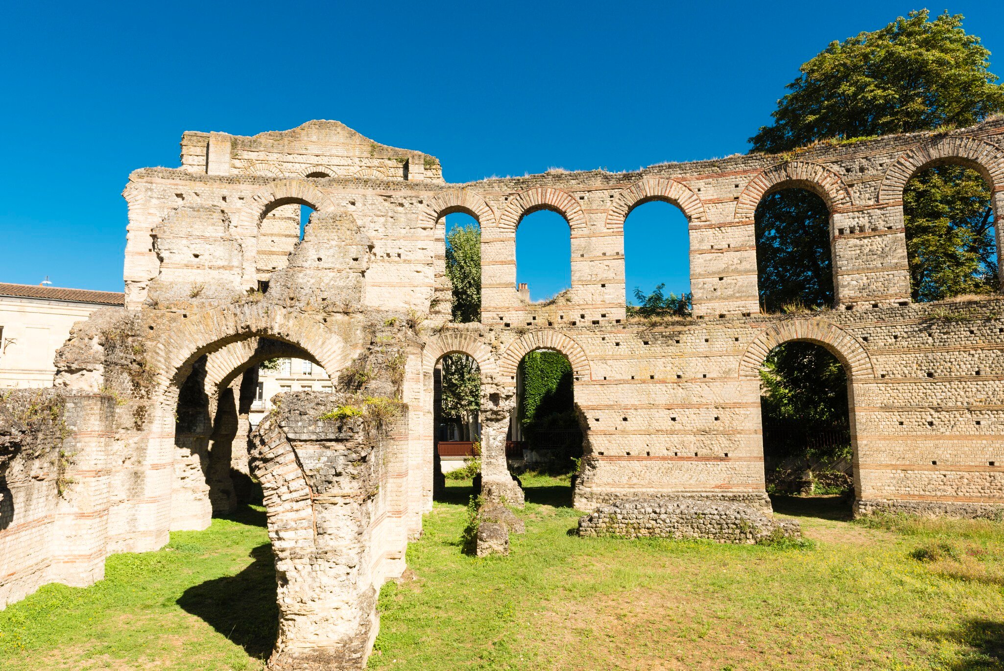 Palais Gallien in Bordeaux, France, are ruins of an old roman amphitheater. The shape of the huge amphitheater, which would have been able to hold about 15,000 spectators, is largely covered over by development.