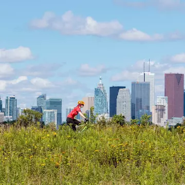 Cycling in front of the skyline from Tommy Thompson Park in Toronto Ontario Canada.