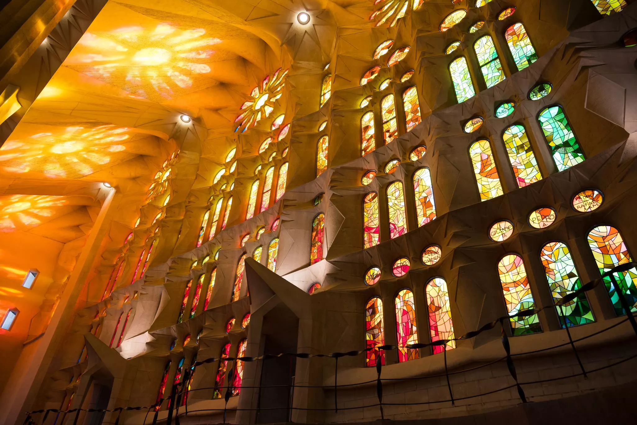 Vividly stained window panes flood the nave of the Sagrada Família with a rainbow of light © Matthew Horwood / Getty Images