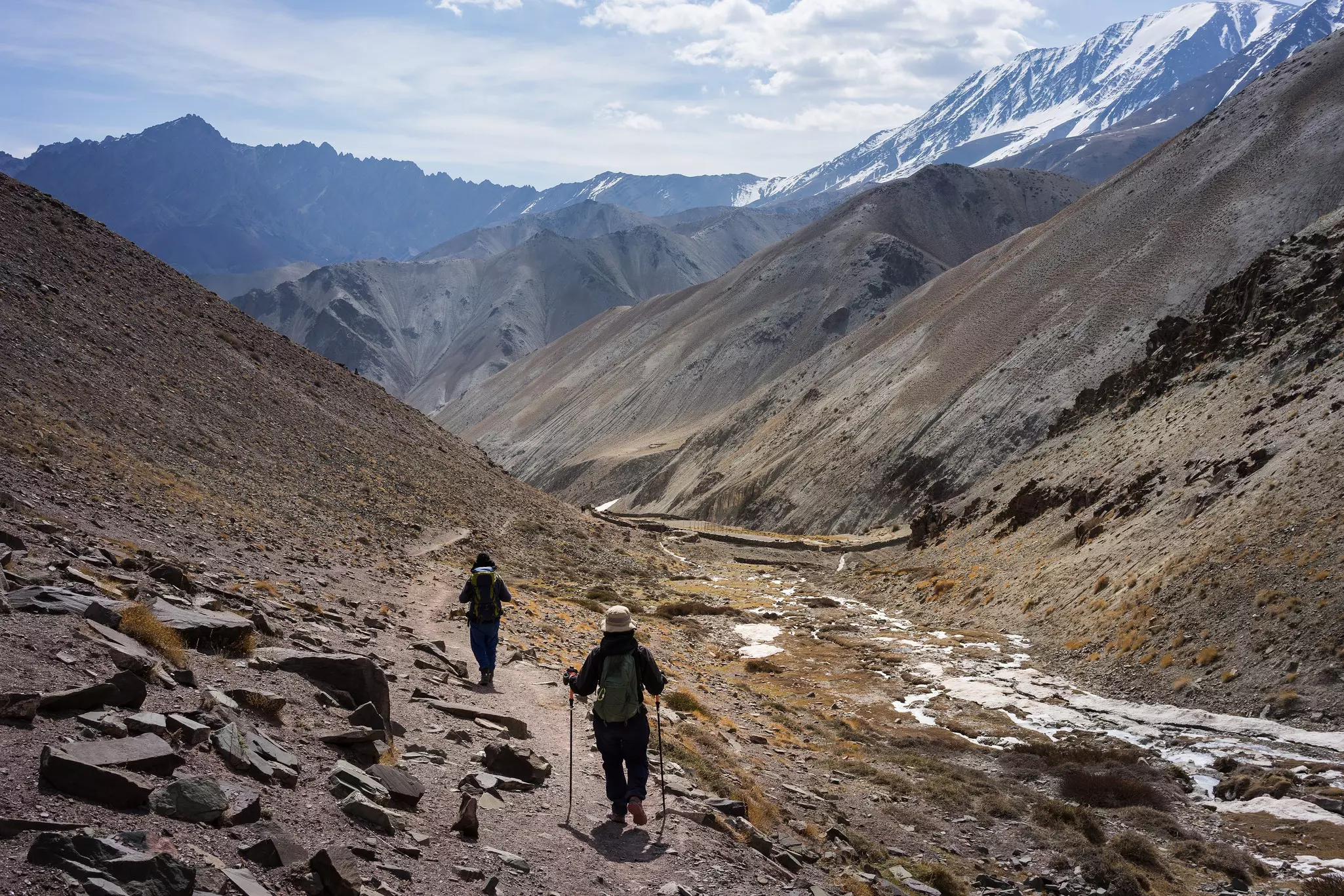 Man and woman hiking on a dry mountainside
