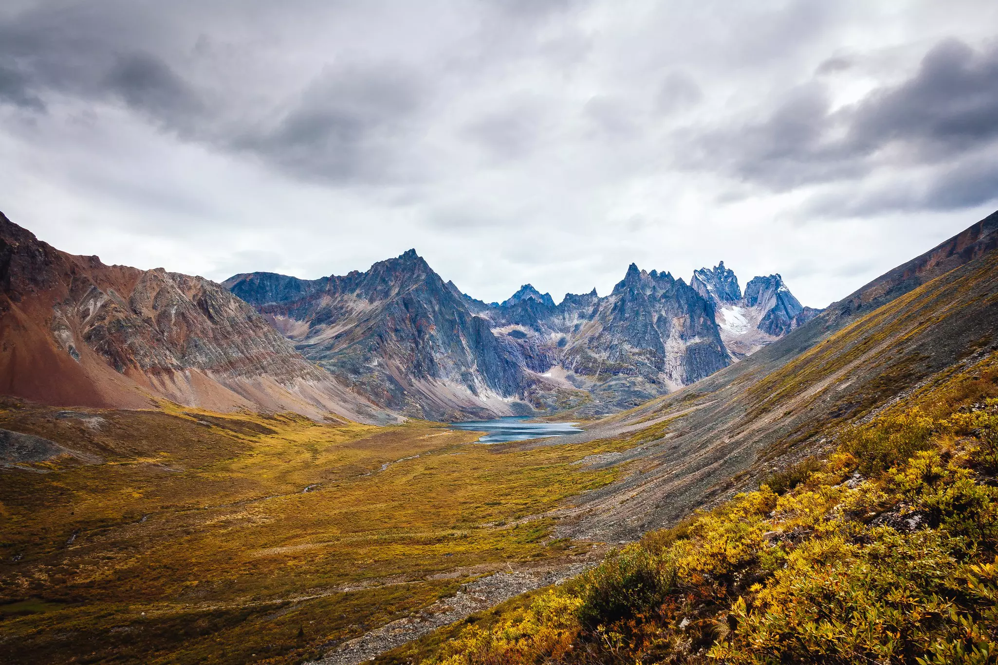 View of the mount Monolith and grizzly lake from the hiking trail of the Tombstone Park in Yukon, Canada. Wide angle shot of the late summer colors., License Type: media, Download Time: 2025-09-19T01:48:44.000Z, User: LP_ABowen, Editorial: false, purchase_order: 65050 - Digital Destinations and Articles, job: Digital, client: Best Canadian hikes, other: Alison Gonner
