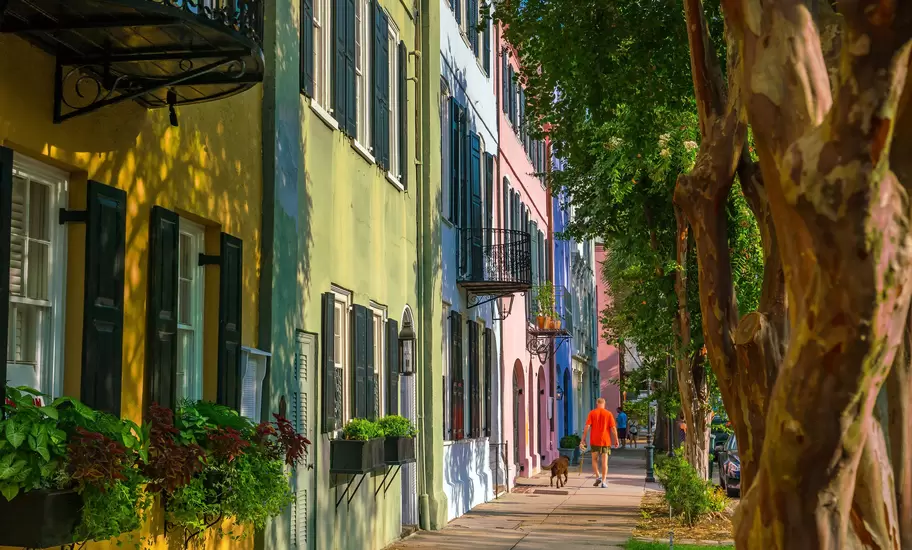 View down Rainbow Row, colorful and well-preserved historic Georgian row houses in Charleston, South Carolina, USA