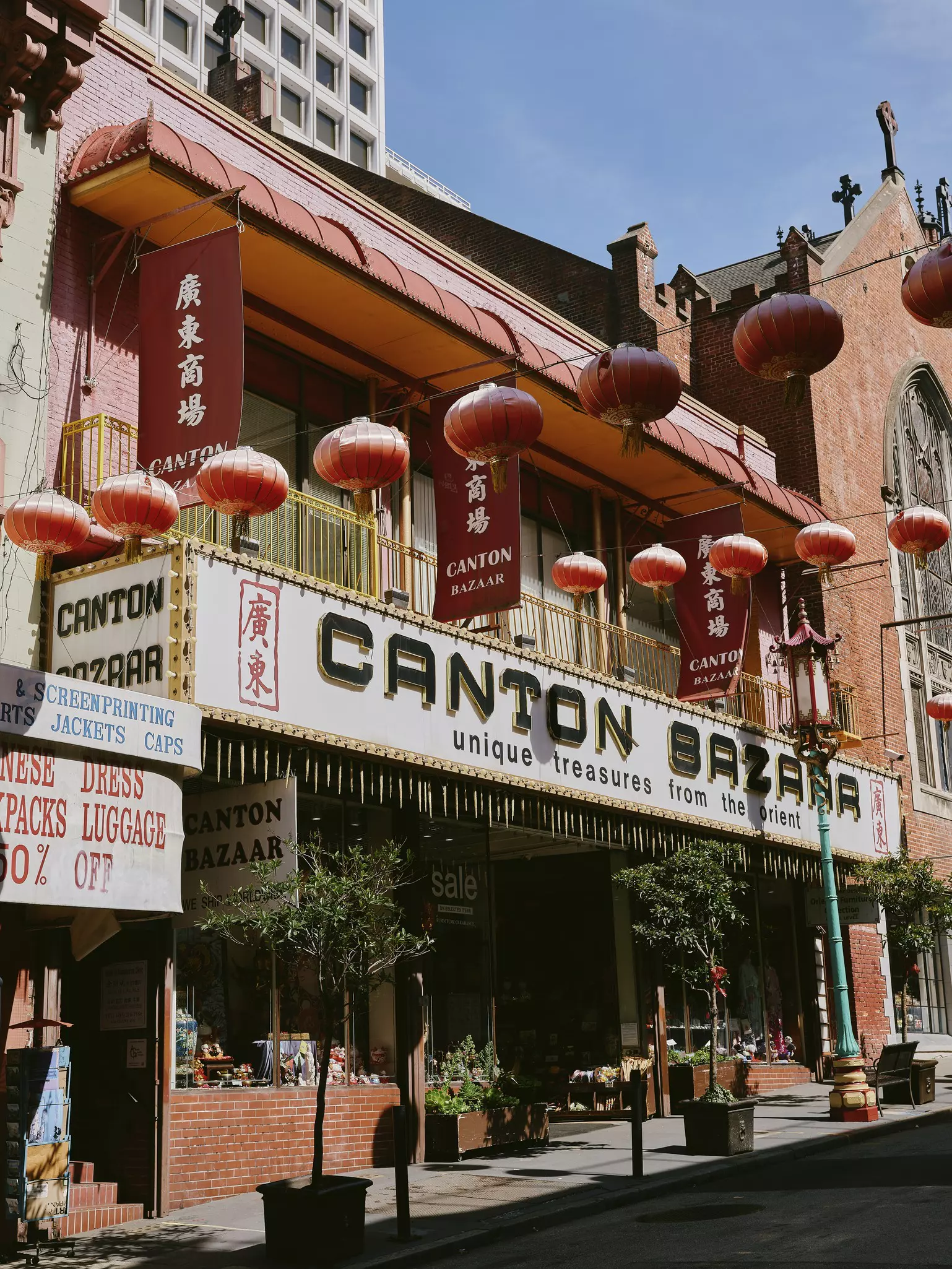 A storefront in a brick building. The sign on it says "Canton Bazaar. Unique treasures from the Orient."