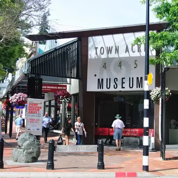 People walking and trees with the exterior of the Nelson Provincial Museum, Trafalgar Street, Nelson, Nelson Region, South Island, New Zealand.